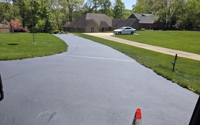 Wide new asphalt driveway in a neighborhood