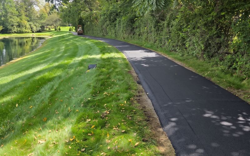 Newly paved walking path beside a pond
